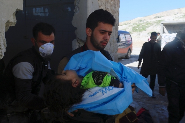 A man carries the body of a dead child, after what rescue workers described as a suspected gas attack in the town of Khan Sheikhoun in rebel-held Idlib